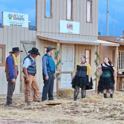 Wild West-themed outdoor performance with actors.